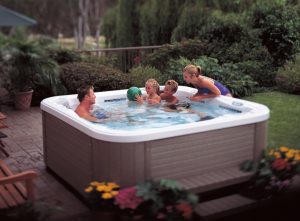 Picture of a family sitting together in a hot tub.