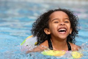 Child having fun swimming in a pool